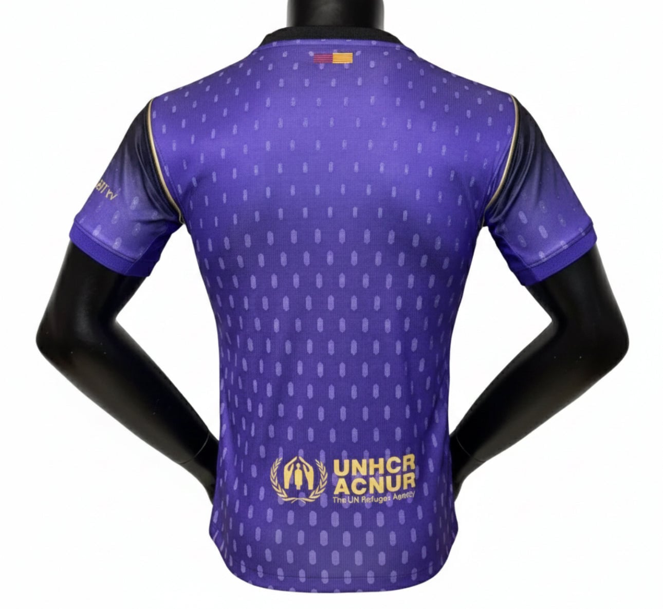 FullSizeRender_a84f32c8-ed98-490f-ac3a-f62ed3ee26c9 | UAE SPORT STORE Back view of a purple UNHCR athletic jersey with a dotted pattern and the gold UNHCR logo at the lower back.