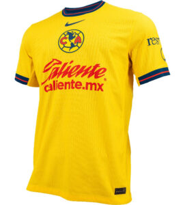 Yellow Club América soccer jersey with red sponsor text 'Caliente.mx' and team crest on chest.
