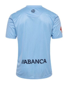 Back view of light blue soccer jersey with ABANCA sponsor text across the lower back and a circular logo at the neck.
