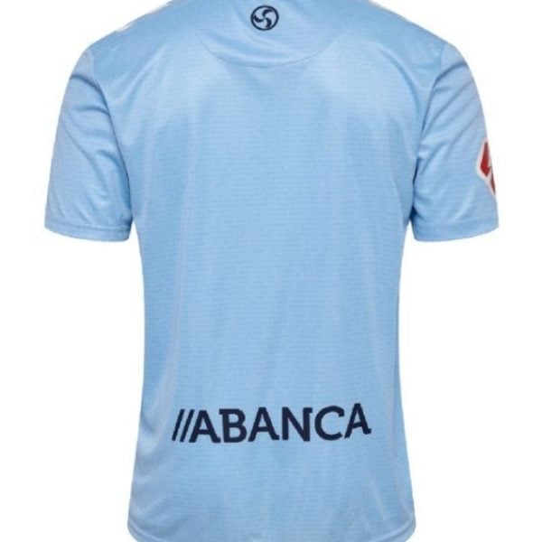 Back view of light blue soccer jersey with ABANCA sponsor text across the lower back and a circular logo at the neck.