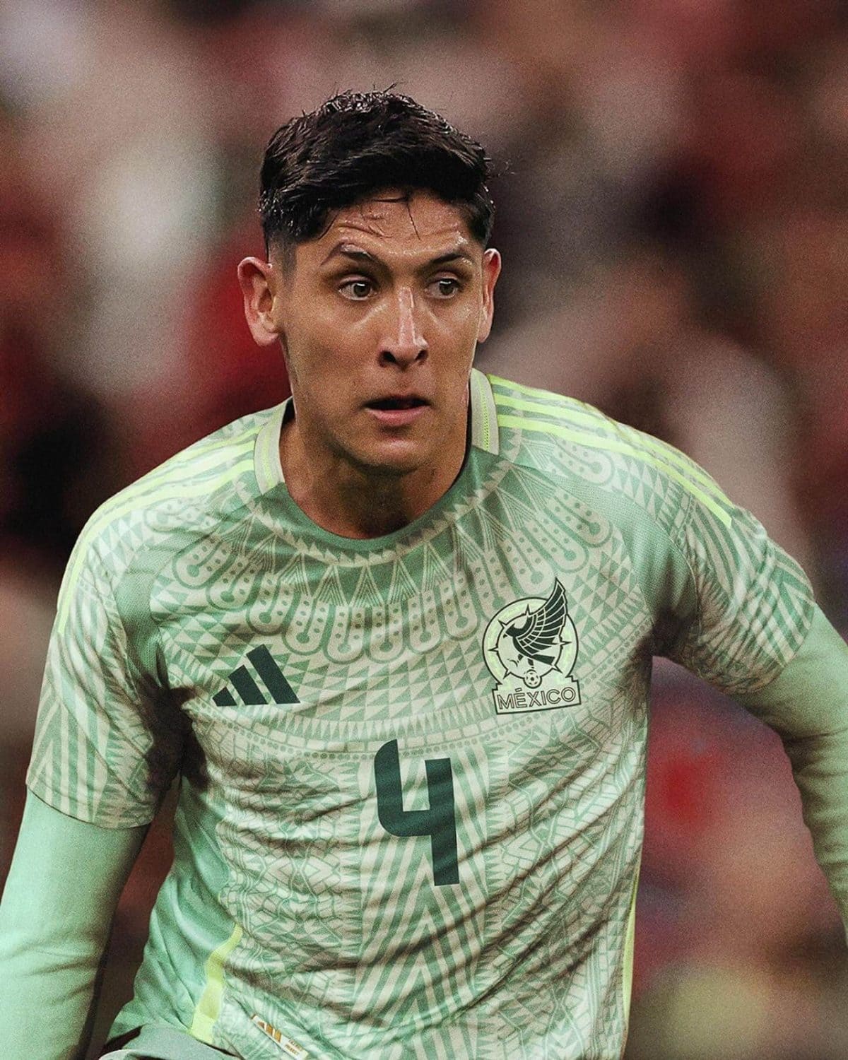 Mexico national team goalkeeper in a light-green patterned jersey awaiting play, number 4 visible on the chest.