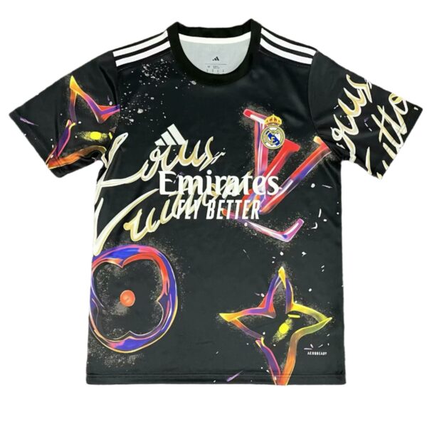 Black Real Madrid football jersey with colorful graffiti graphics and white 'Fly Emirates' text and striped shoulders.
