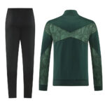 Green athletic jacket with patterned chevron panels across back and sleeves, paired with black track pants