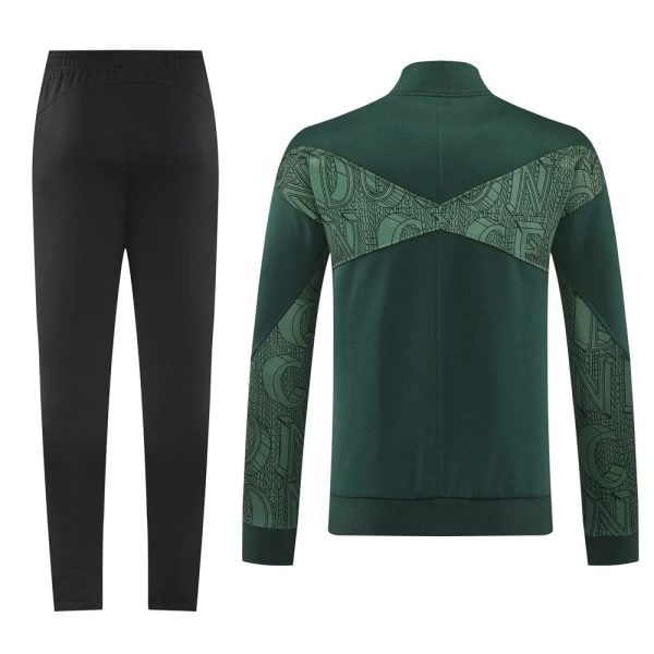 Green athletic jacket with patterned chevron panels across back and sleeves, paired with black track pants