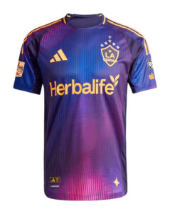 Purple LA Galaxy soccer jersey featuring Herbalife sponsor logo across the chest, Adidas emblem, team crest, and yellow accents on sleeves and collar.