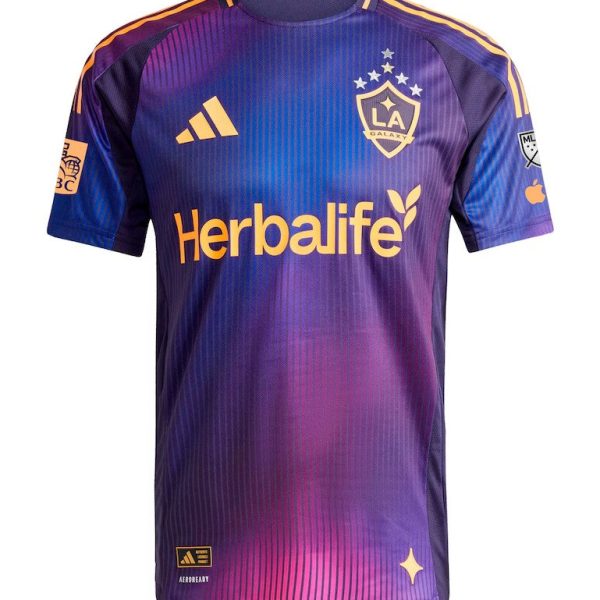 Purple LA Galaxy soccer jersey featuring Herbalife sponsor logo across the chest, Adidas emblem, team crest, and yellow accents on sleeves and collar.