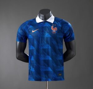 HE5lhFybwAANlT1 | UAE SPORT STORE Blue France national team football jersey with a white collar, gold Nike swoosh, and FFF crest on the chest.