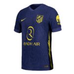Blue Atlético Madrid jersey with yellow Riyadh Air sponsor and crest on the chest.