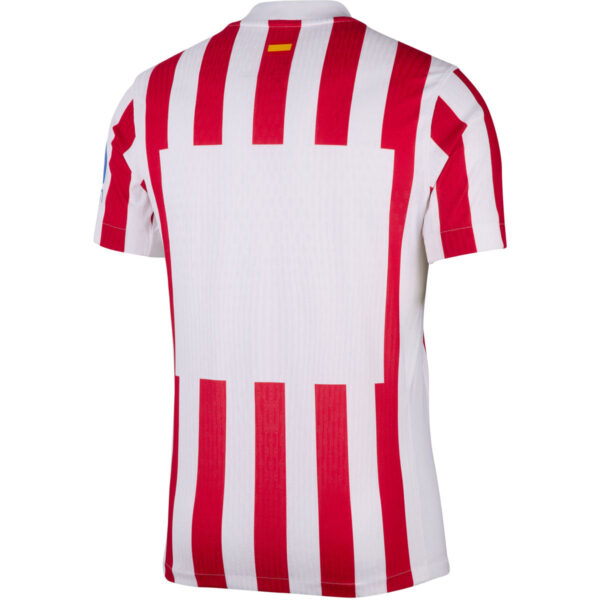 Back view of a white jersey with bold vertical red stripes on the back.