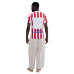 Back view of a person wearing a red and white striped jersey with 'Visit Rwanda' on the back, beige cargo pants, and sneakers