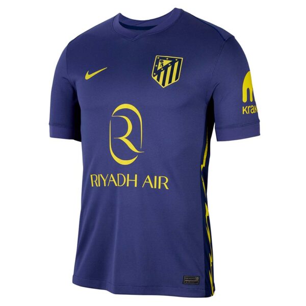 Blue Atlético Madrid jersey with yellow Riyadh Air sponsor, Nike swoosh, and club crest on the chest.