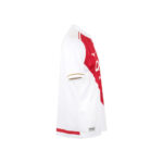 White sports jersey with red diagonal front panel, shown from the side, featuring a small brand logo near the hem.