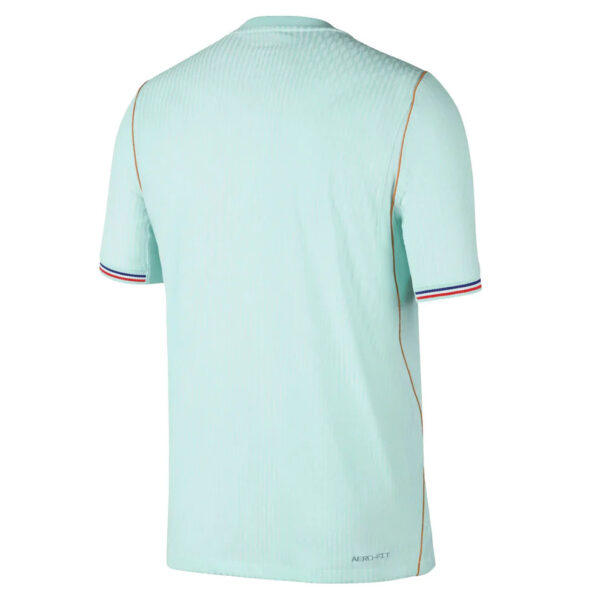 Back view of a light mint polo shirt with orange side piping and blue-red striped sleeve cuffs; Aero-Fit branding near the hem.
