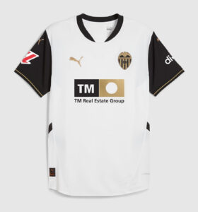 White soccer jersey with black sleeves featuring Valencia CF crest and Puma logo; sponsor TM Real Estate Group on front.