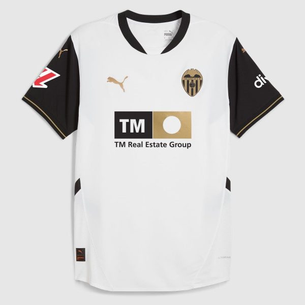 White soccer jersey with black sleeves featuring Valencia CF crest and Puma logo; sponsor TM Real Estate Group on front.