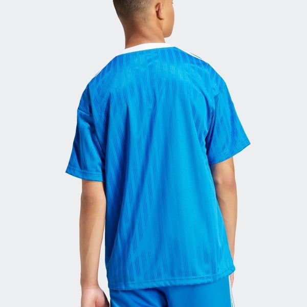 Back view of a person wearing a bright blue athletic jersey and matching shorts, seen from the shoulders down to mid-thighs.
