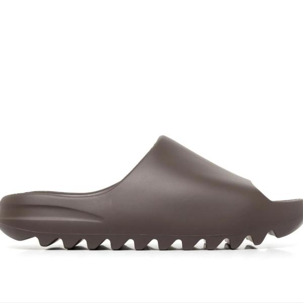 Brown slide sandal with a single strap and a chunky serrated sole.