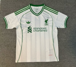 IMG-6038 | UAE SPORT STORE White soccer jersey with green piping, striped shoulders, and Standard Chartered sponsor logo on front