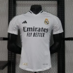 White Real Madrid football jersey on a mannequin, featuring the club crest and Emirates Fly Better sponsor text.