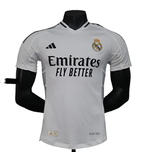 White Real Madrid football jersey on a mannequin, featuring the club crest and 'Emirates Fly Better' sponsor text