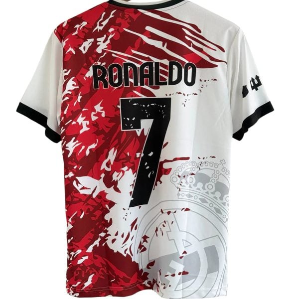 Back of a white and red graphic soccer jersey hanging on a wooden hanger, with 'RONALDO' and the number 7 and a crown motif on the design.