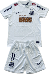 White soccer jersey featuring Santos FC crest, Nike swoosh, Banco BMG sponsor; NETSHOES on sleeves; includes matching white shorts with crest.