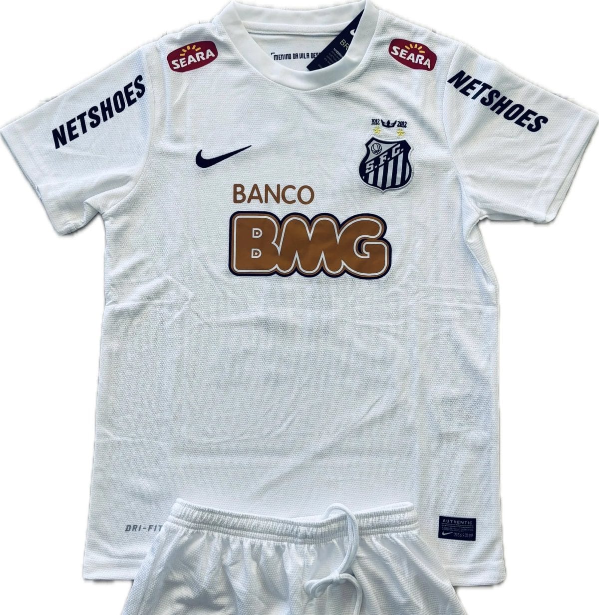 White athletic jersey shown from the chest area, featuring NETSHOES on both sleeves, a Nike swoosh, team crest on the left chest, and a large BMG logo on the front.