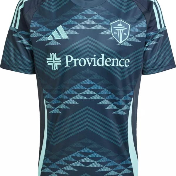Dark blue soccer jersey with light teal geometric pattern, Providence sponsor across chest, Adidas-style stripes on shoulders, and a crest on the left chest.