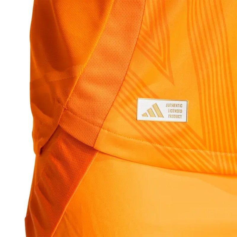 IpEFNmQO7rQEbIX | UAE SPORT STORE Close-up of orange athletic fabric with a small 'Authentic Licensed Product' badge on the chest area.