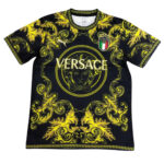 Black Versace T-shirt with a vivid yellow baroque pattern, Medusa emblem in a circle, and 'VERSACE' text across the chest.