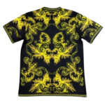 Black T-shirt with ornate gold baroque pattern and Greek key border on edges.