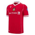 Red soccer jersey with white collar and piping, crest on left chest and 'UNITED' sponsor across front; blue patch on right sleeve.