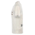 JG8A0174-800x800-ok | UAE SPORT STORE Side view of a white soccer jersey with a subtle decorative pattern and red trim on the sleeve.