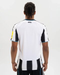 Back view of a person wearing a white sports jersey with black vertical stripes and blue trim; text at neck reads 'HOWAY THE LAIDS'.