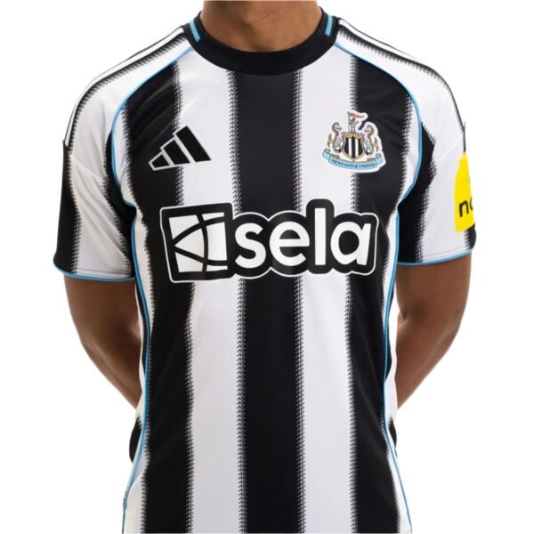 Close-up of a Newcastle United football jersey with black and white vertical stripes, showing the Adidas logo and club crest on the chest.