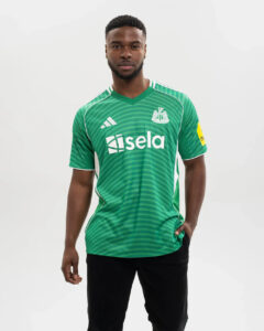 JJ2245_MOD_1 | UAE SPORT STORE Man in a green striped soccer jersey with white sponsor text 'sela' and a team crest on the chest, standing against a neutral background.