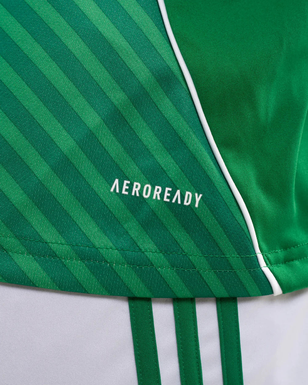 JJ2245_MOD_13 | UAE SPORT STORE Close-up of a green striped athletic jersey with white piping and the AEROREADY logo.