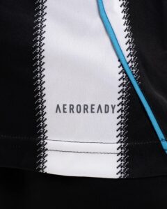 Close-up of athletic fabric with a white central panel, black stitched edges, and a bright blue seam; partial text 'AERO READY' visible at the bottom.