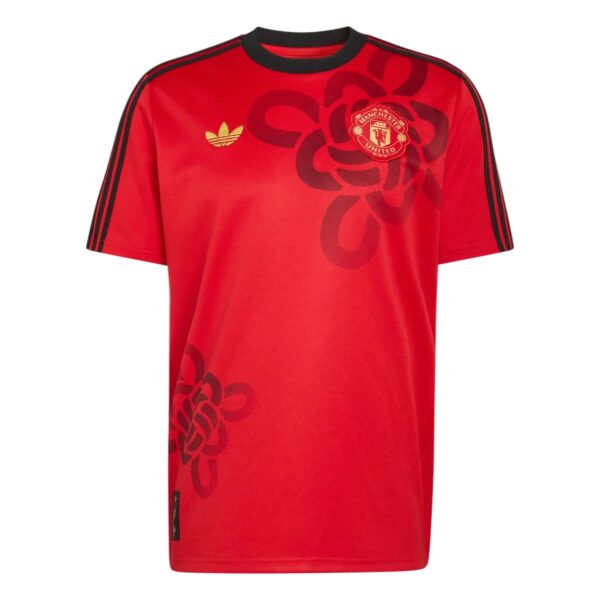 Red Manchester United Adidas football jersey with a dark red floral pattern and crest on the chest.