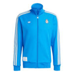 Light blue Real Madrid Adidas track jacket with a full zipper, white stripes down the sleeves, and crest on the chest (front view).