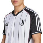 Close-up of a person wearing a Juventus soccer jersey with white and black vertical stripes and team logos on the chest.
