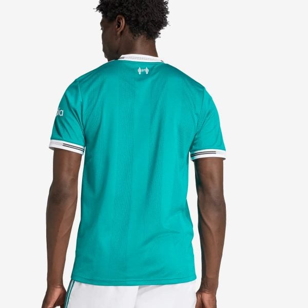 Back view of a man wearing a teal sports jersey with white trim and white shorts, facing away from the camera.