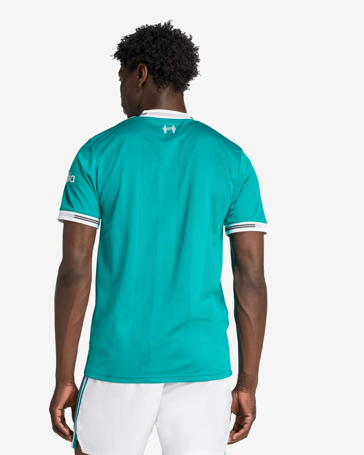 JV6427_4_APPAREL_OnModel_BackView_custom_1-lowres | UAE SPORT STORE Back view of a man wearing a teal sports jersey with white trim and white shorts, facing away from the camera.