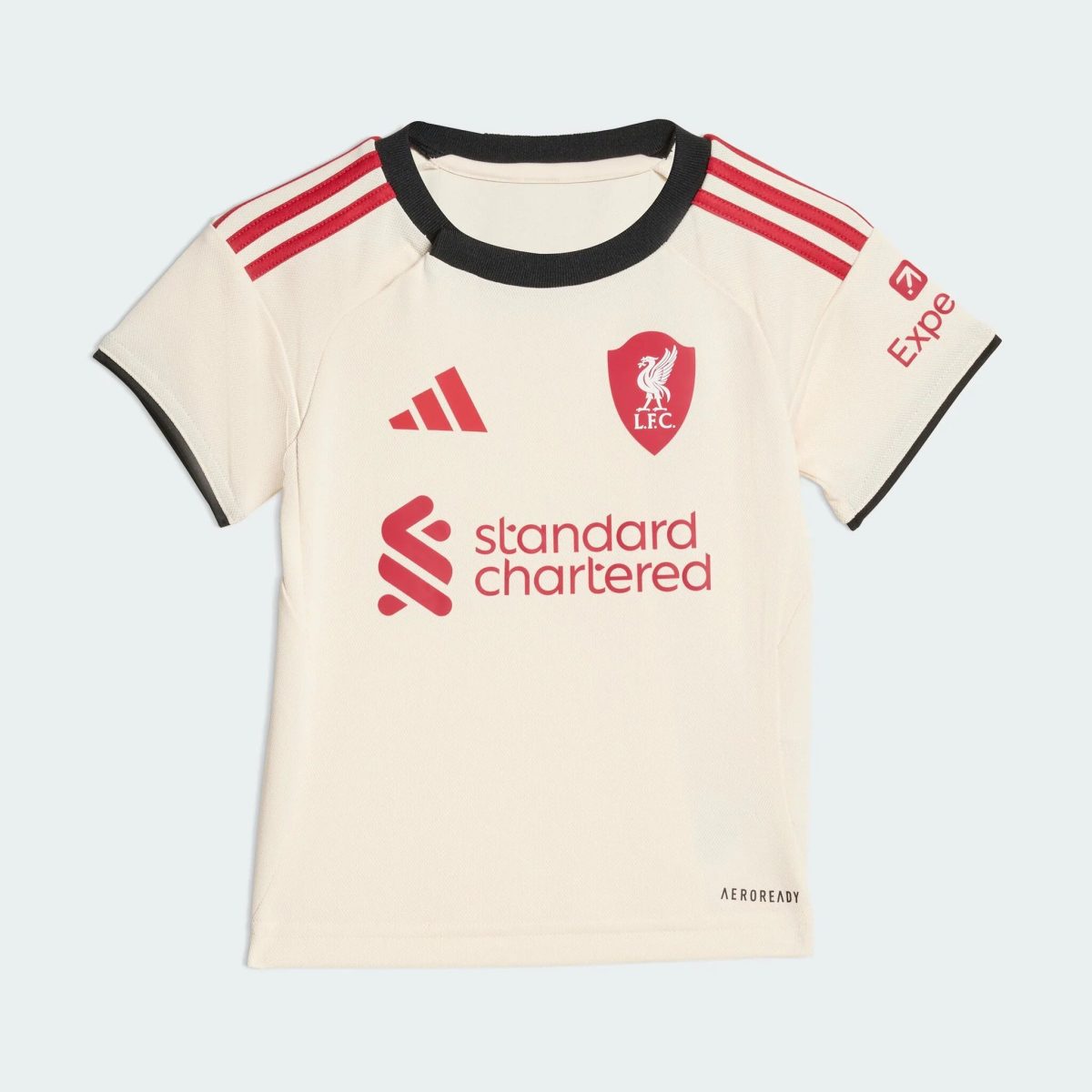 White football jersey front with red shoulder stripes, club crest, Adidas logo, and 'standard chartered' sponsor text; Aeroready badge visible.