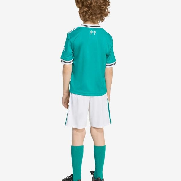 Back view of a child wearing a teal soccer jersey with white trim, white shorts, teal socks, and black cleats.