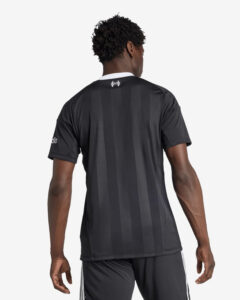 Back view of a man wearing a black striped athletic jersey with a white collar, facing away from the camera.