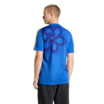 Man wearing a blue athletic t-shirt with a large floral graphic on the back, shown from behind.