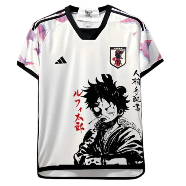 White soccer/football jersey with black trim featuring a large black-and-white manga-style portrait of a young man, red vertical Japanese text on the left, JFA crest on the chest, and an Adidas logo on the opposite side.