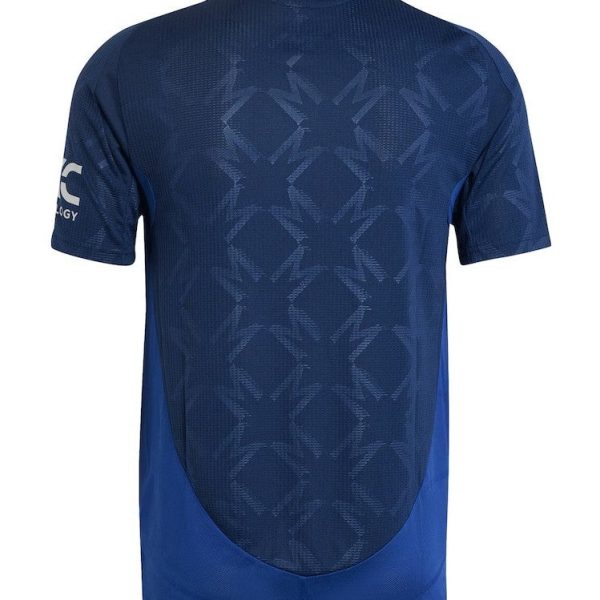 Back view of a blue athletic jersey with a geometric mesh pattern and curved hemline at the bottom edge on a plain background, showing sleeve logo on the left.