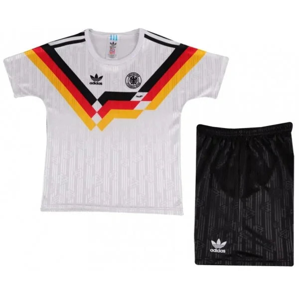 Youth Germany national team soccer kit: white jersey with black, red, and gold chevron and crest, paired with black shorts.